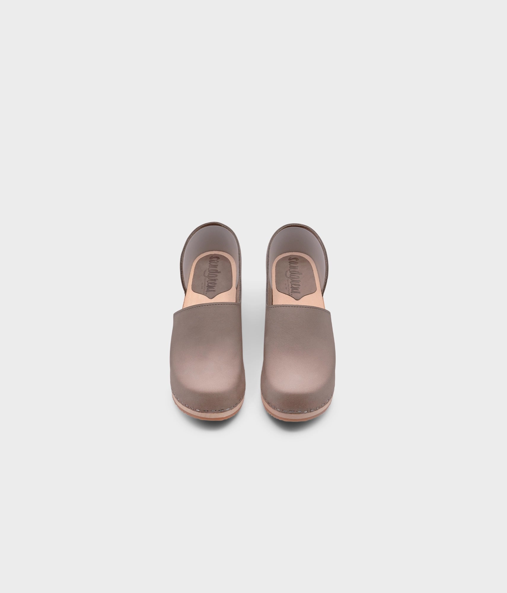 high heeled closed-back clogs in stone grey nubuck leather stapled on a light wooden base
