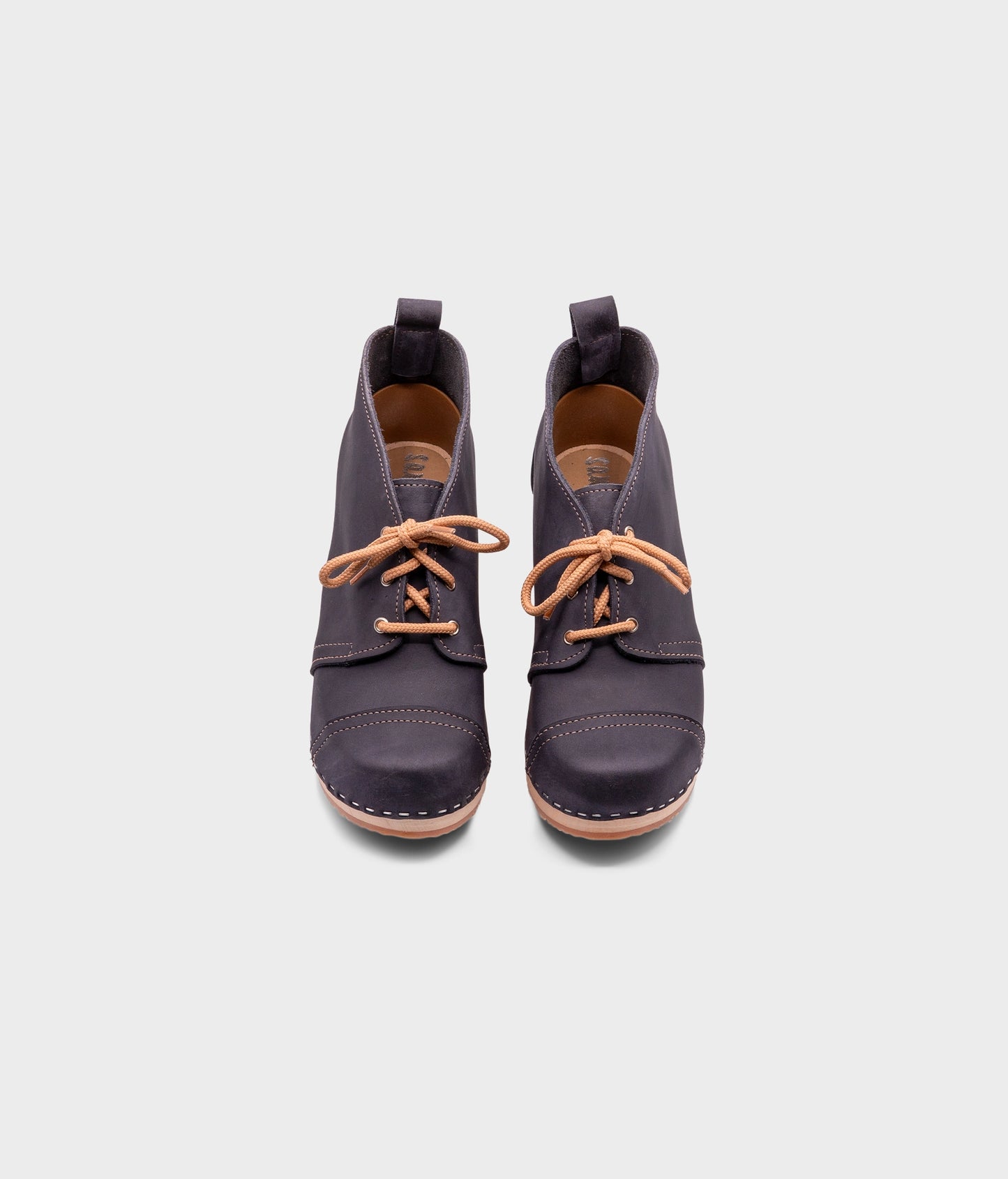 high heeled chukka clog boots in navy blue nubuck leather stapled on a light wooden base with beige laces