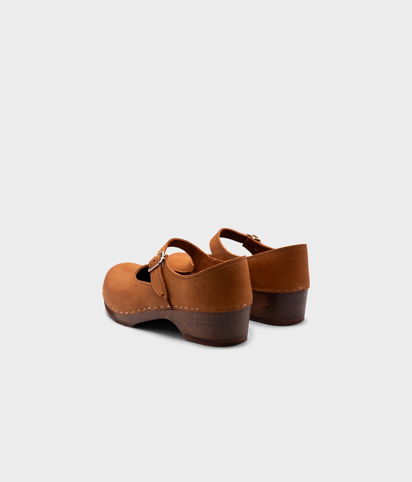 Mary Jane wooden clogs in light brown nubuck leather stapled on a dark wooden base