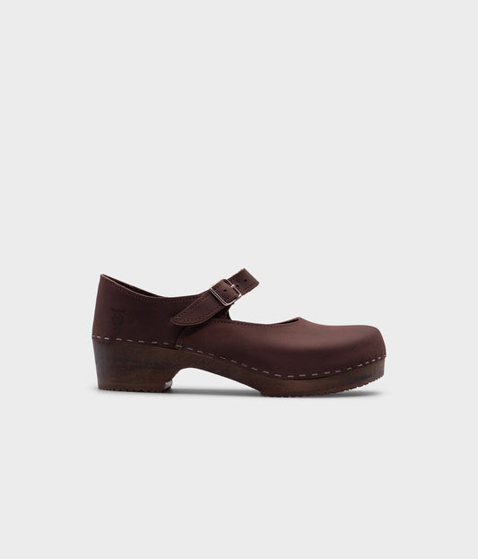 Mary Jane wooden clogs in dark brown nubuck leather stapled on a dark wooden base