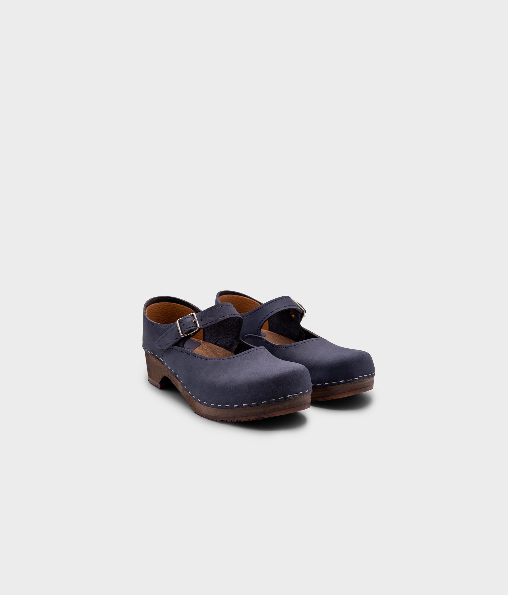Mary Jane wooden clogs in navy blue nubuck leather stapled on a dark wooden base