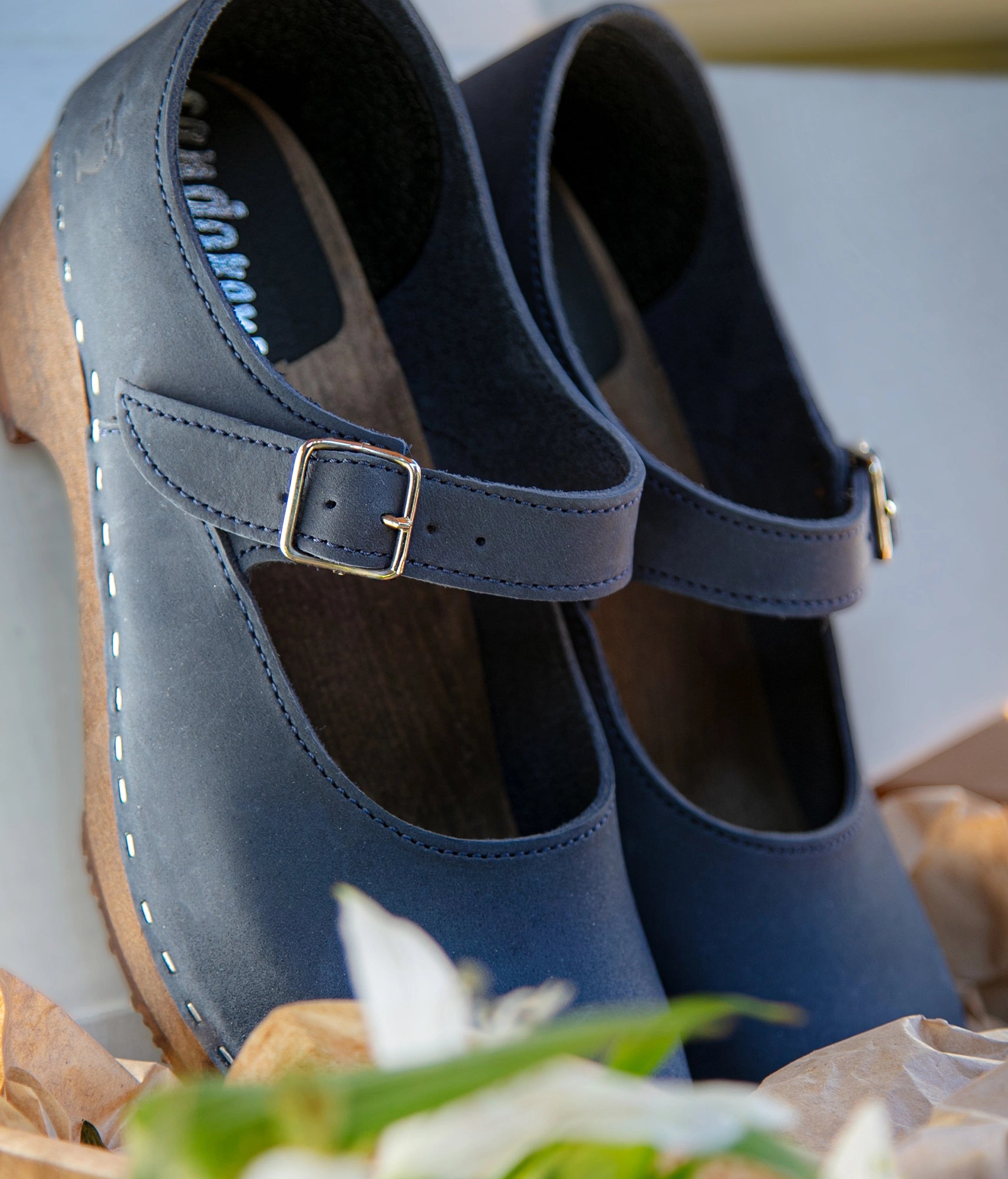 Mary Jane wooden clogs in navy blue nubuck leather stapled on a dark wooden base