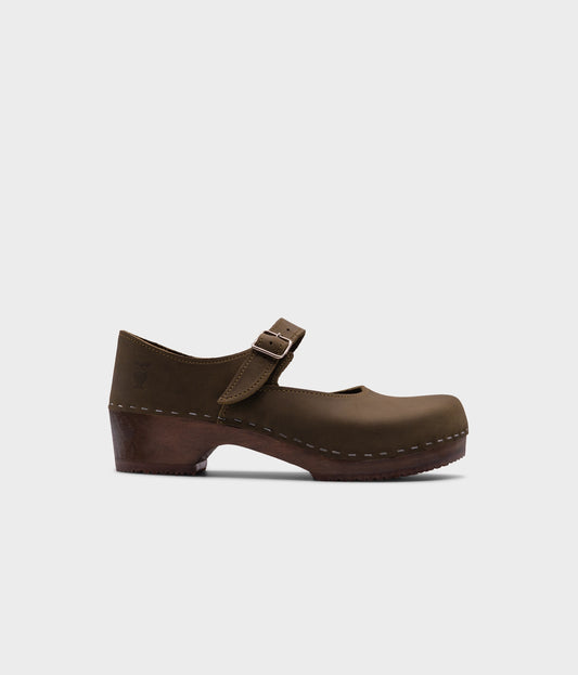 Mary Jane wooden clogs in olive green nubuck leather stapled on a dark wooden base