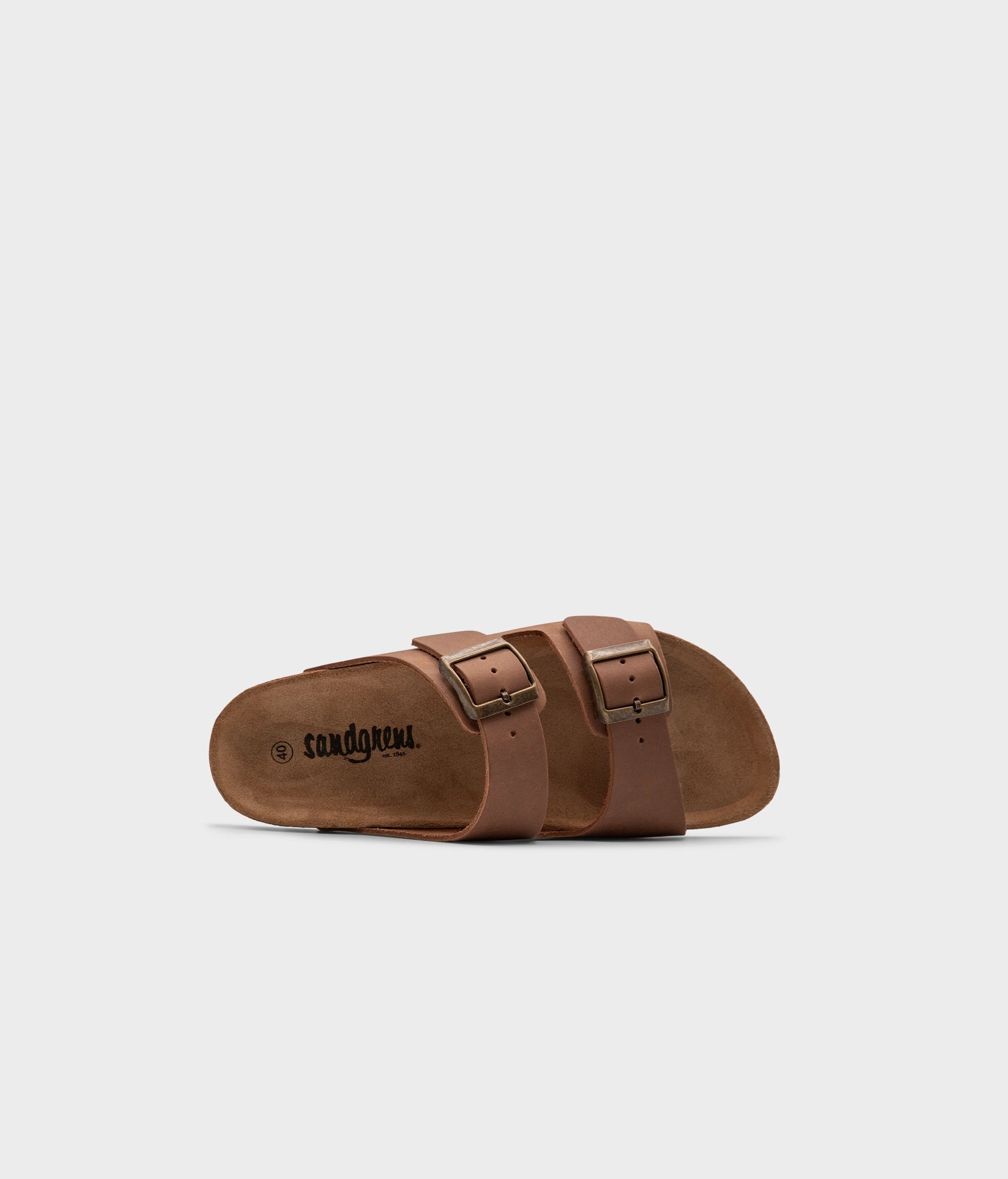 classic cork sandal with two straps in full-grain light brown nubuck leather, suede footbed and brass gold buckles