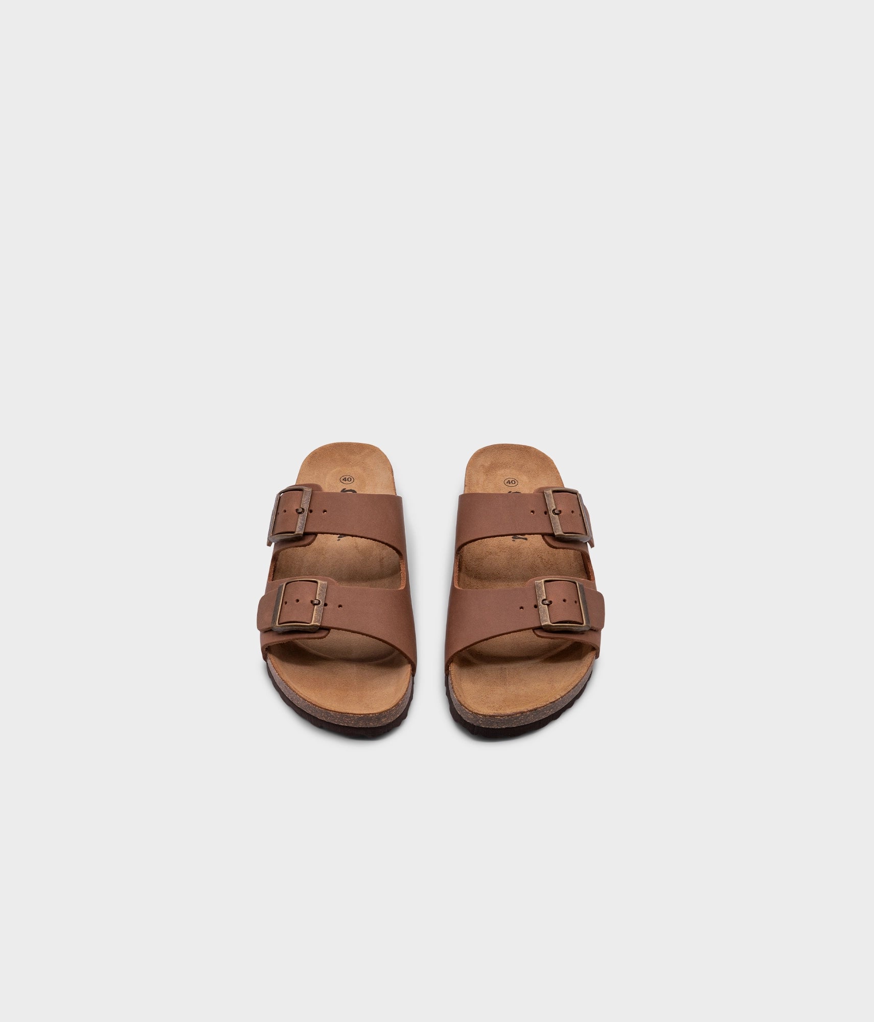 classic cork sandal with two straps in full-grain light brown nubuck leather, suede footbed and brass gold buckles