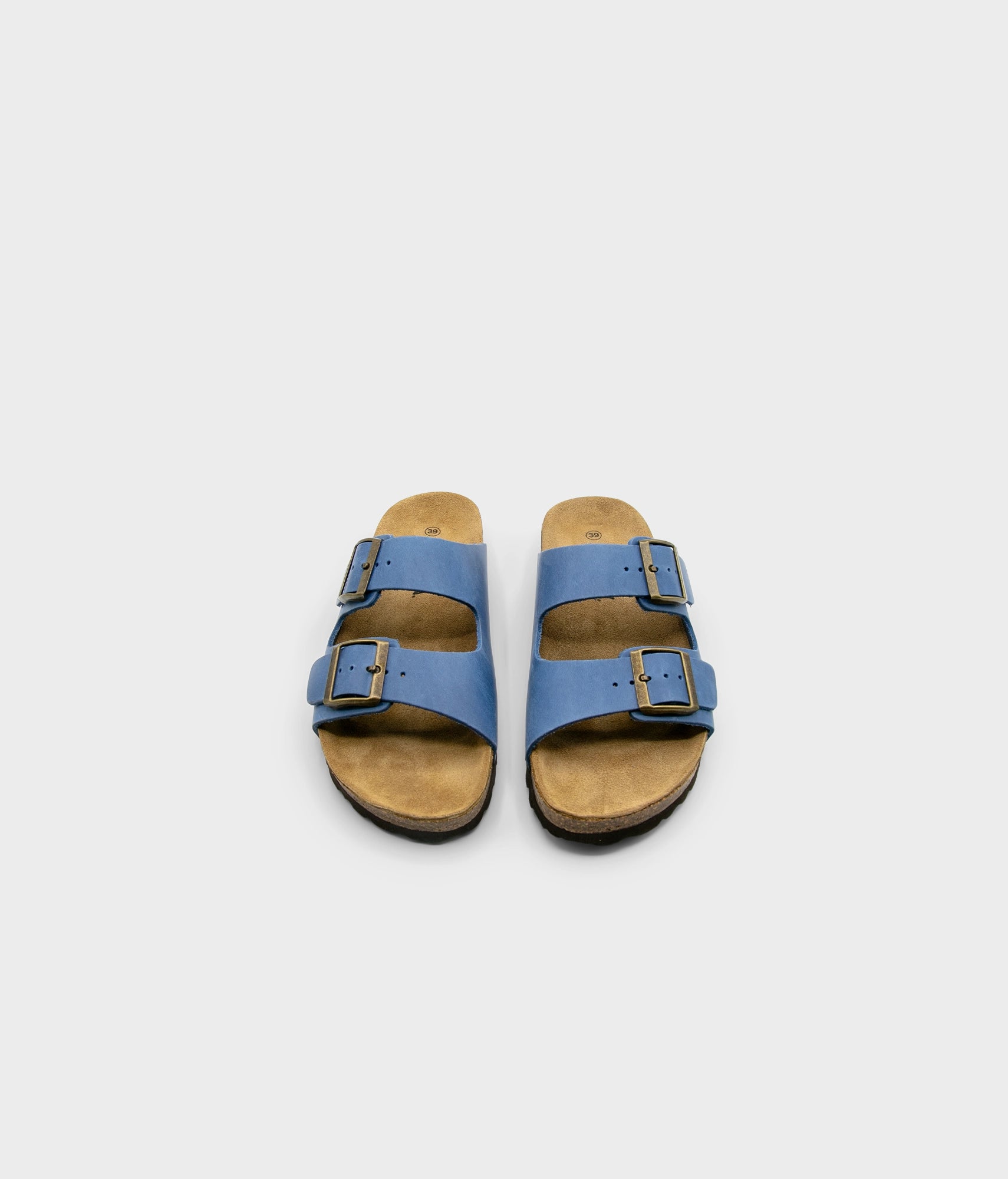 classic cork sandal with two straps in full-grain blue nubuck leather with a blue tint, suede footbed and brass gold buckles