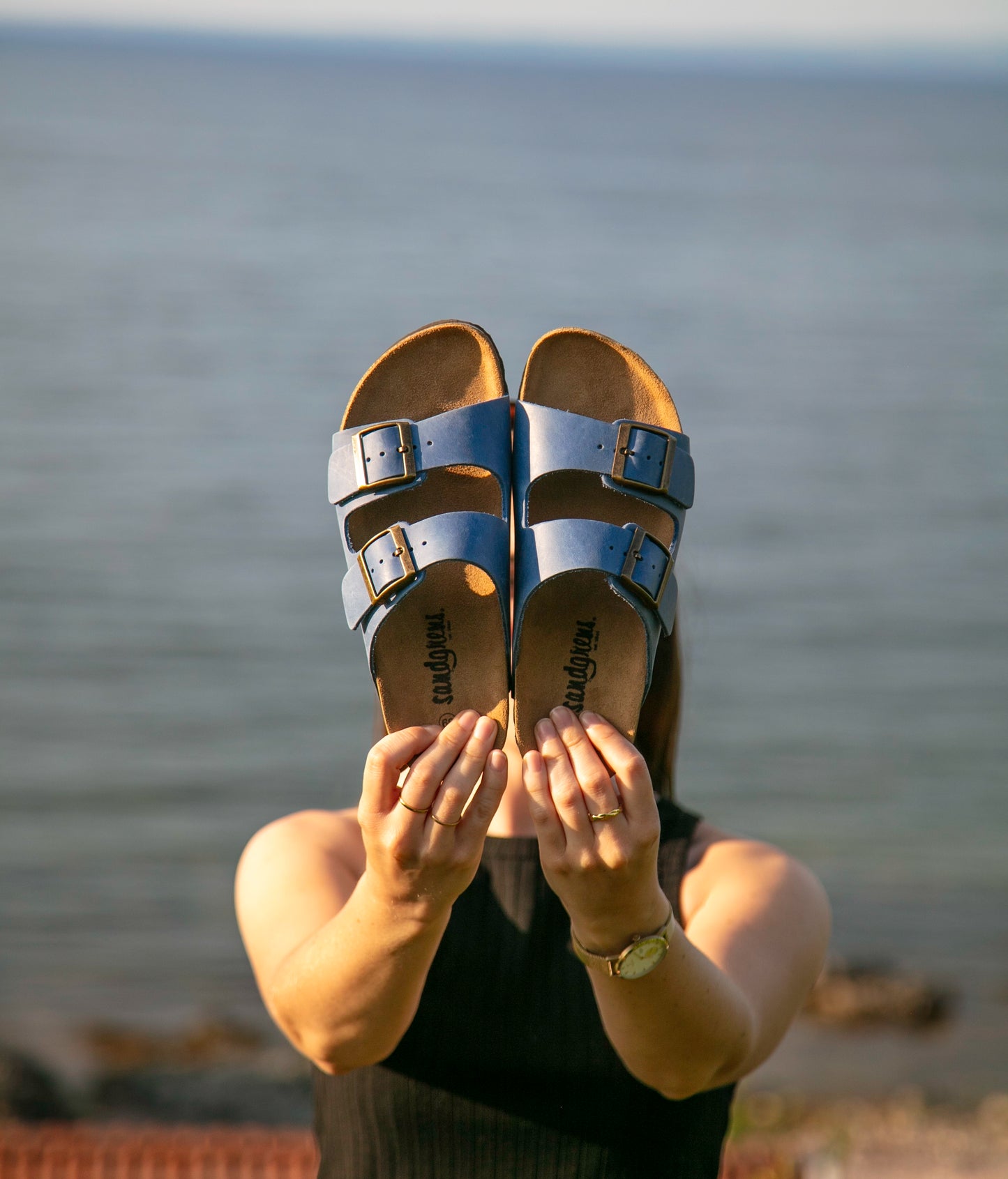 classic cork sandal with two straps in full-grain blue nubuck leather with a blue tint, suede footbed and brass gold buckles
