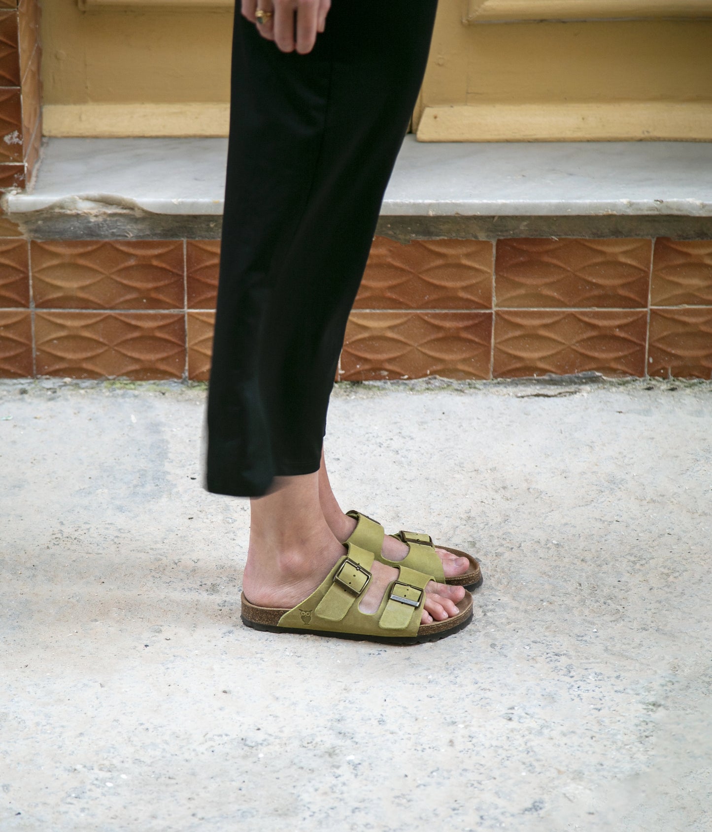 classic cork sandal with two straps in full-grain sage green nubuck leather with a blue tint, suede footbed and brass gold buckles