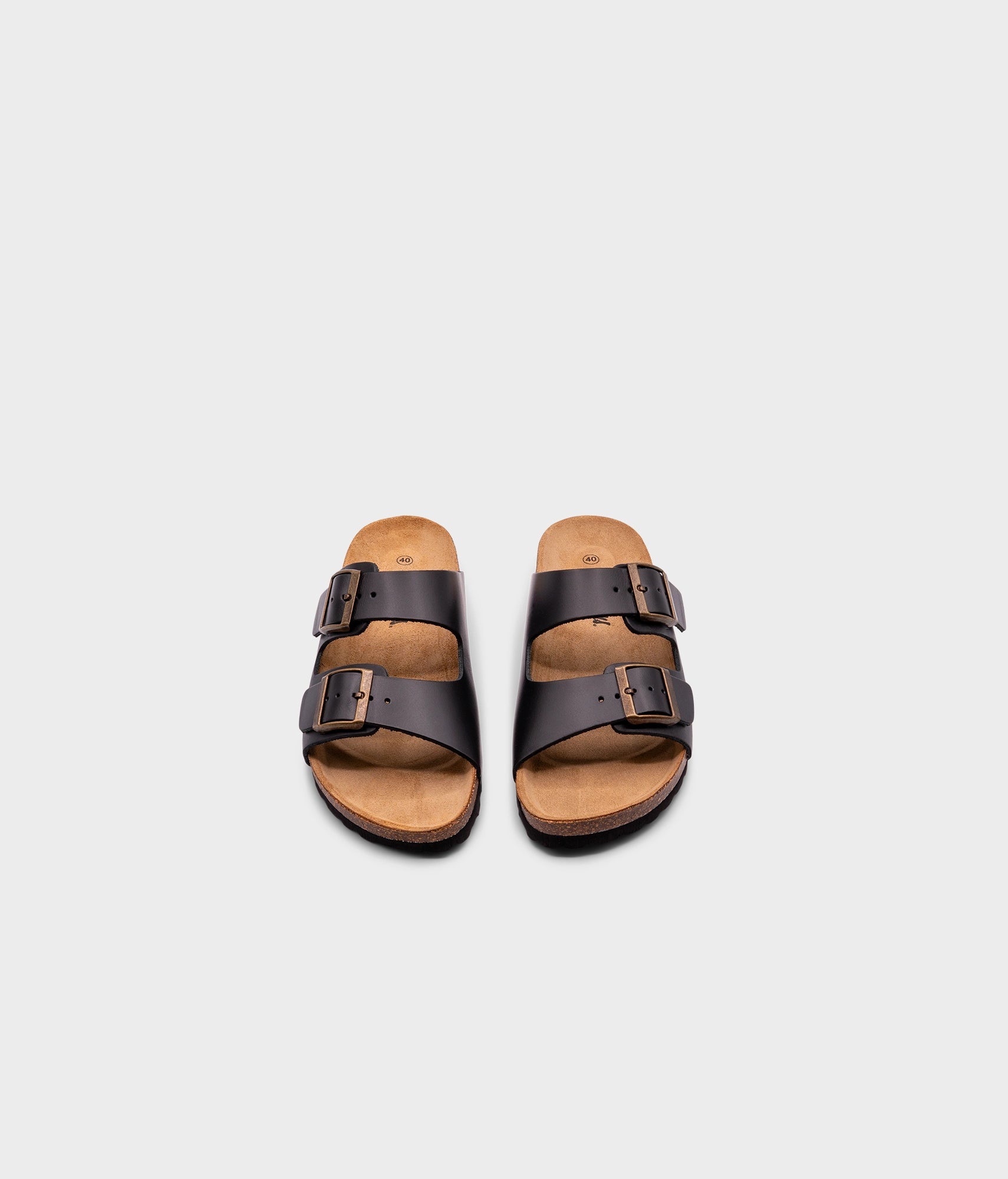classic cork sandal with two straps in top-grain black vegetable tanden leather, suede footbed and brass gold buckles