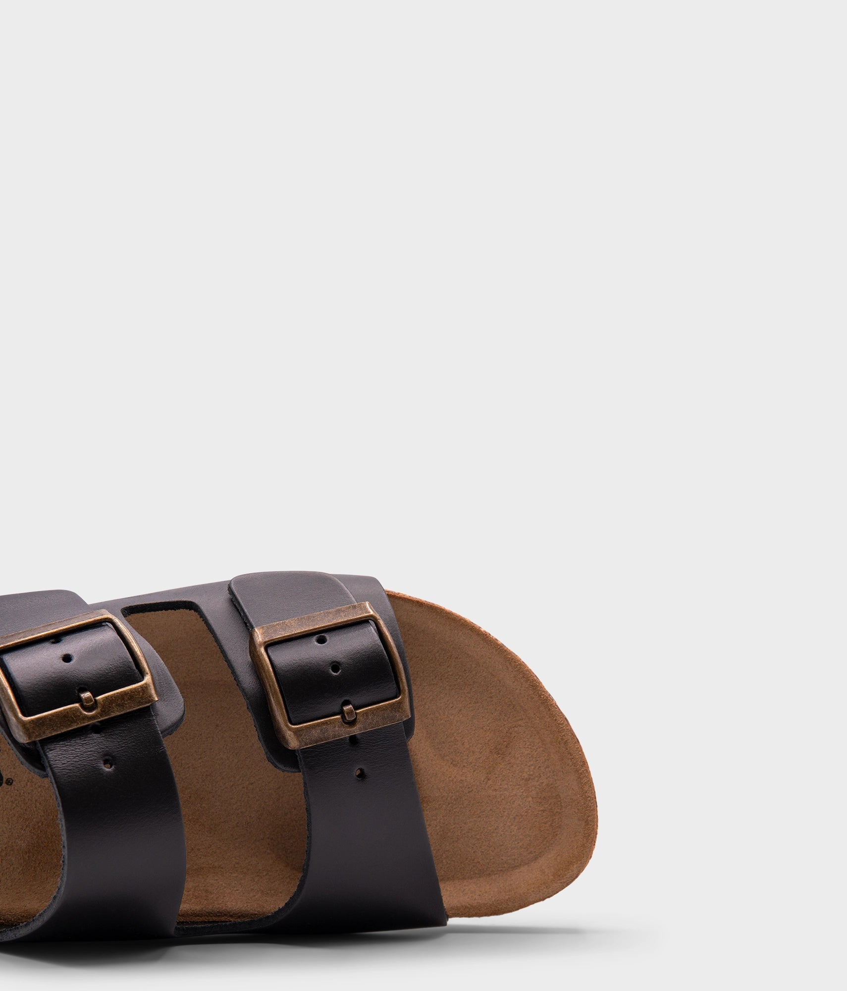 classic cork sandal with two straps in top-grain black vegetable tanden leather, suede footbed and brass gold buckles