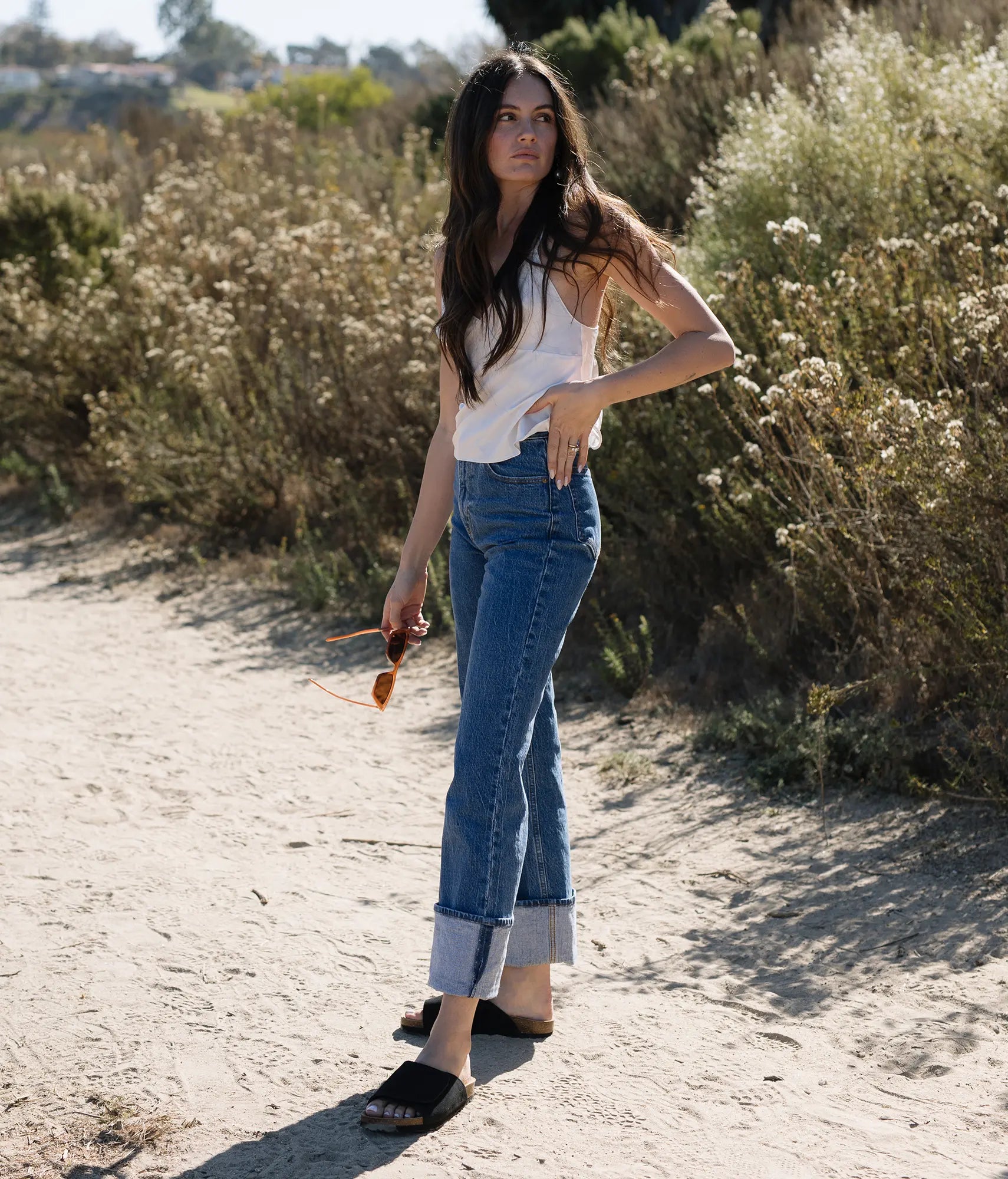 Woman wearing Vigo velcro cork sandals in Sandstone black ember, suede footbed and black EVA outersole