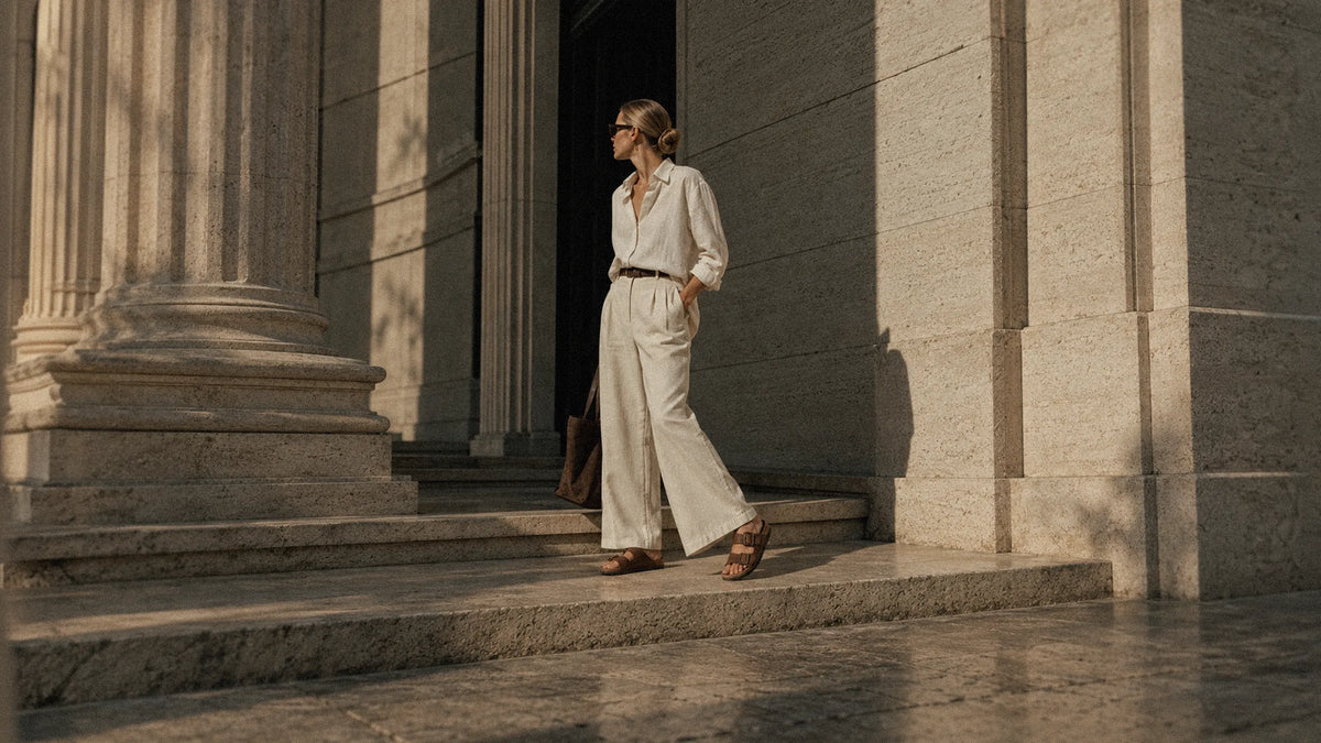 A woman in a wearing brown strappy sandgrens costa cork sandals.